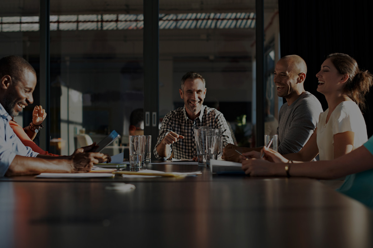Boardroom meeting with people laughing